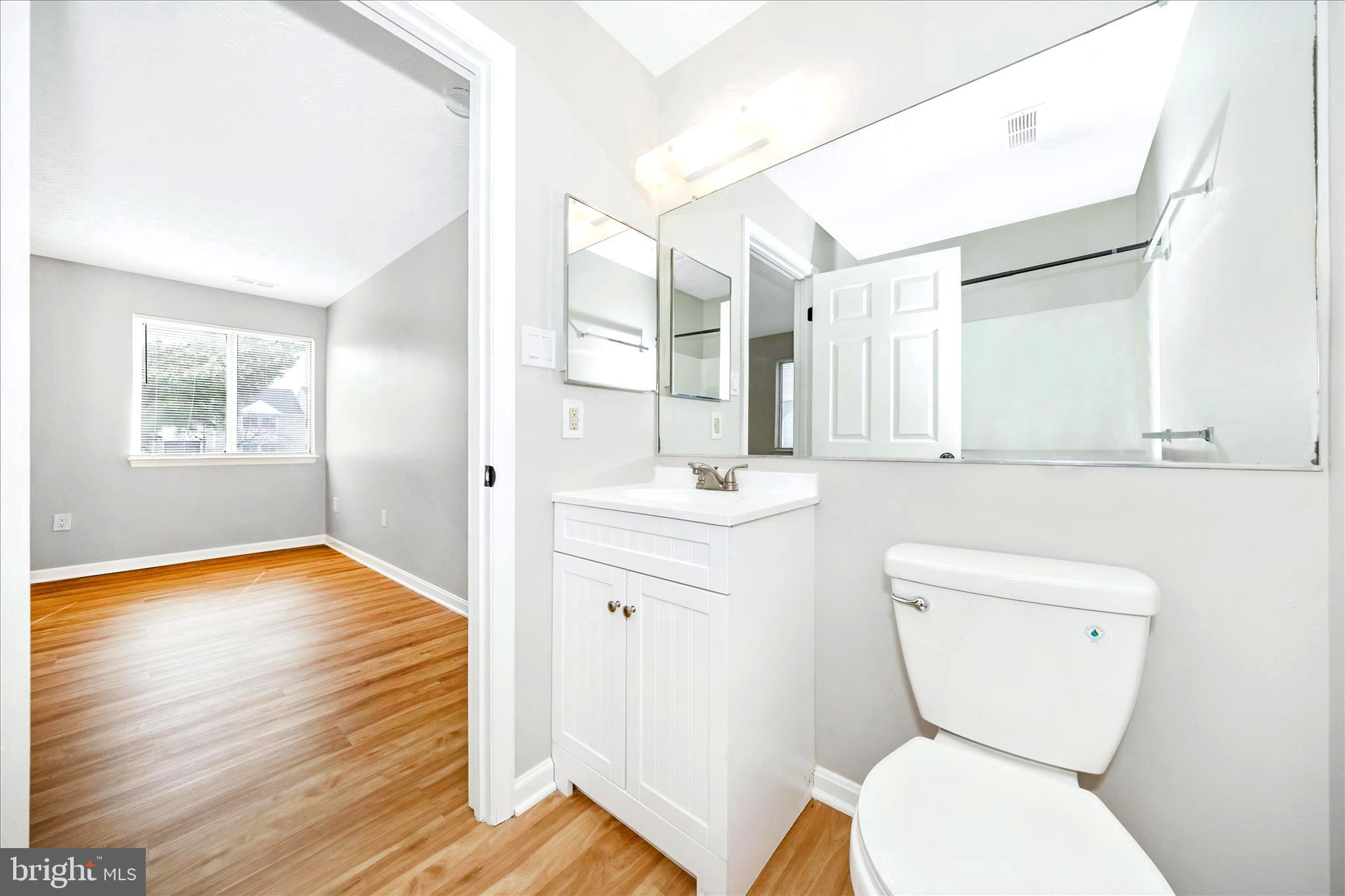2137 Wainwright Court, Unit 1B Frederick, MD 21702 - Photo 29 of 55 a bathroom with a toilet a sink and a mirror