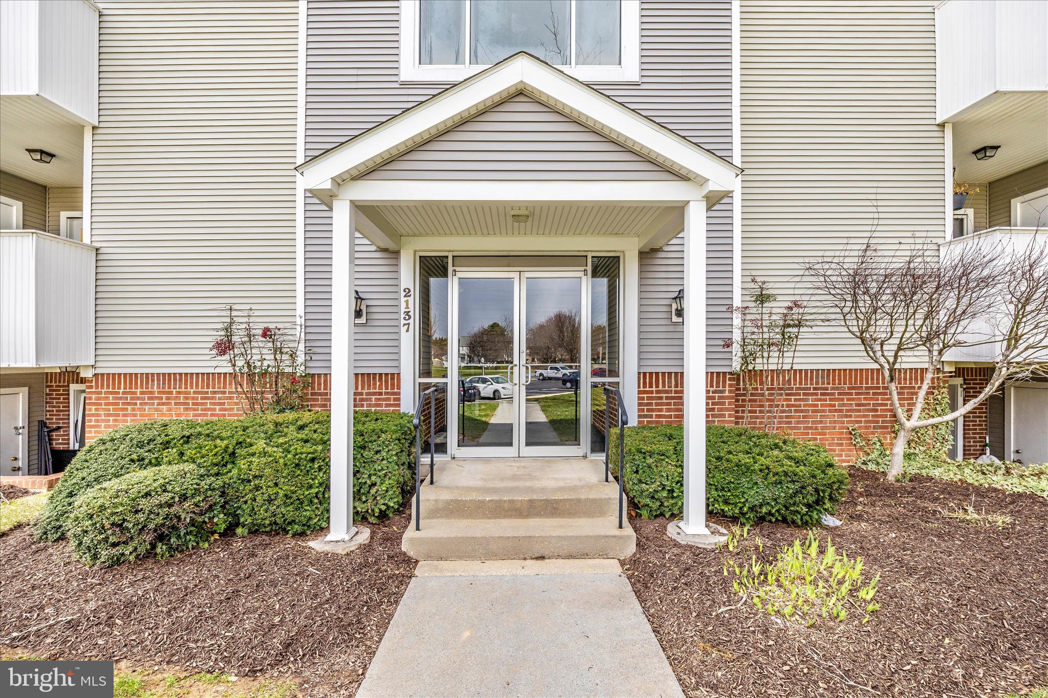 2137 Wainwright Court, Unit 1B Frederick, MD 21702 - Photo 48 of 55 a front view of a house with garden