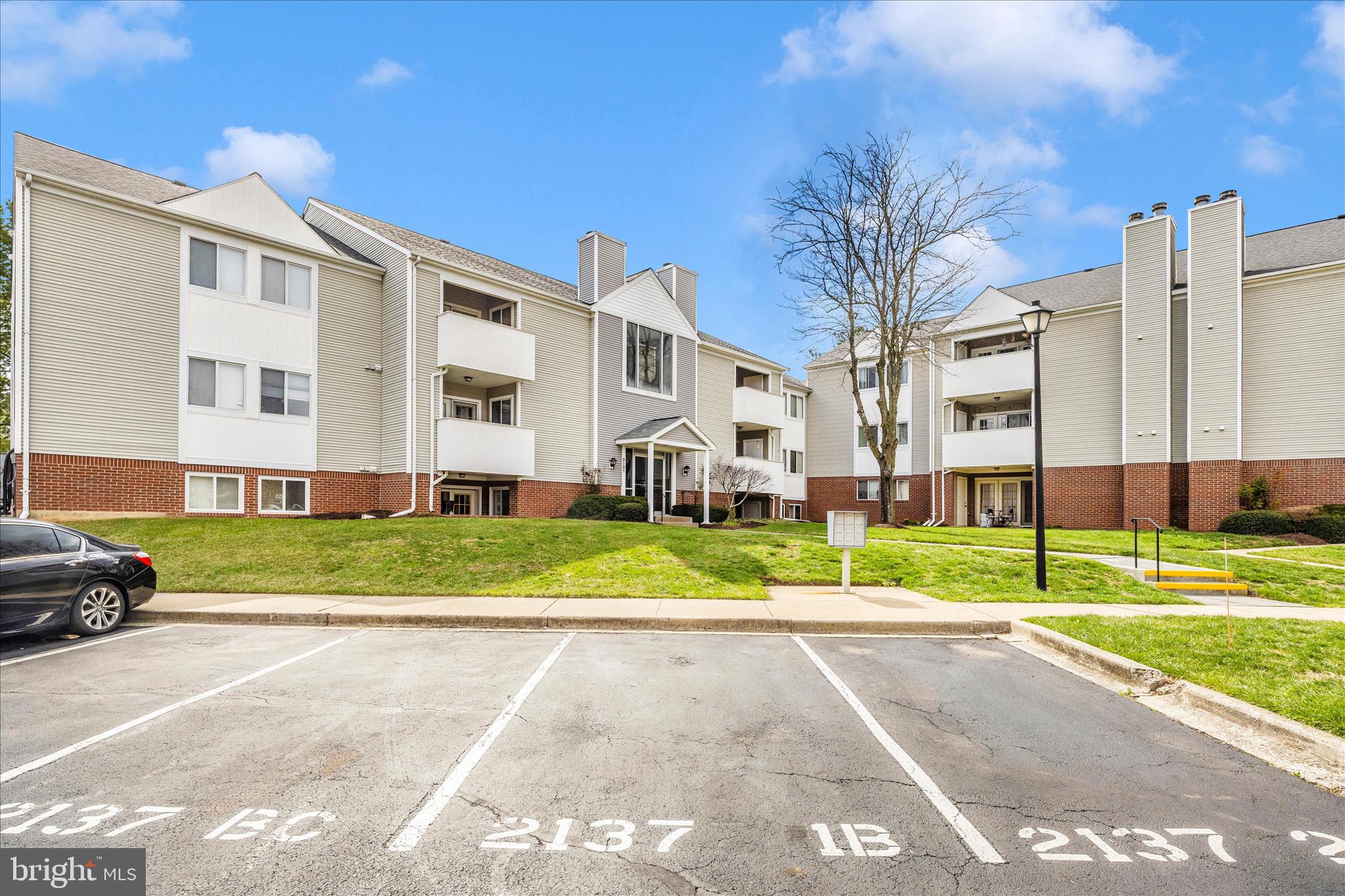 2137 Wainwright Court, Unit 1B Frederick, MD 21702 - Photo 51 of 55 a view of a big house with a yard and plants