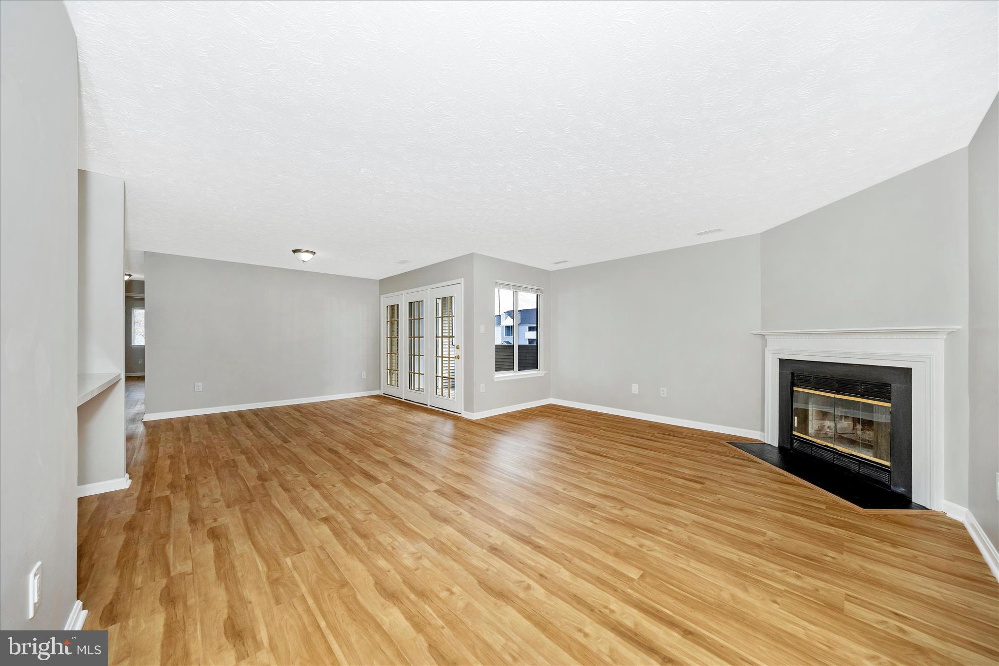 2137 Wainwright Court, Unit 1B Frederick, MD 21702 - Photo 6 of 55 a view of empty room with wooden floor and fireplace