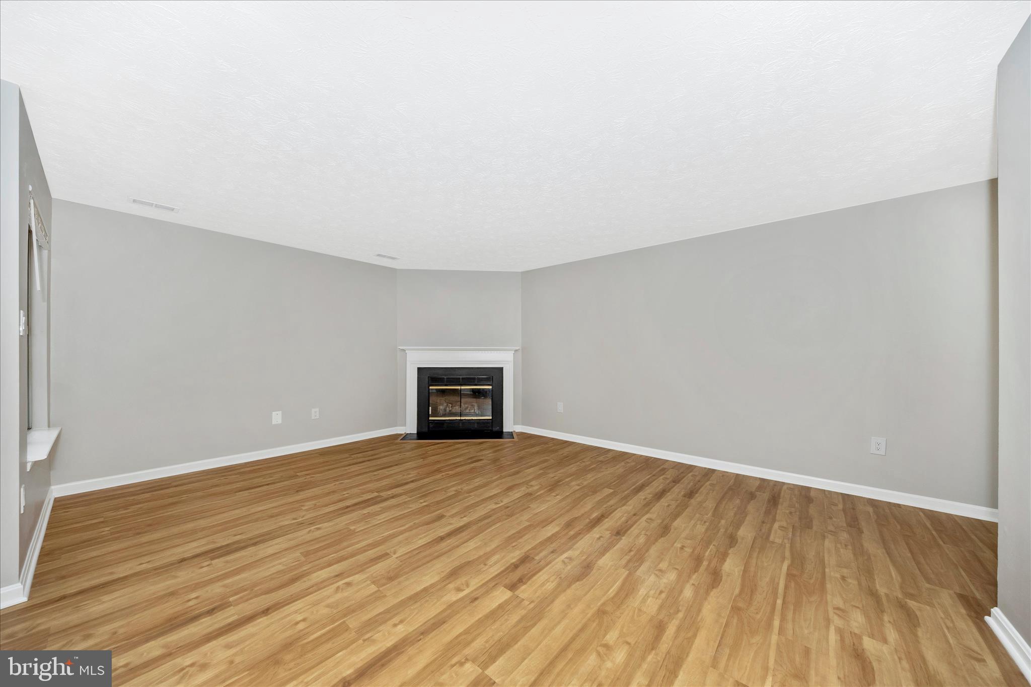 2137 Wainwright Court, Unit 1B Frederick, MD 21702 - Photo 7 of 55 a view of an empty room with wooden floor