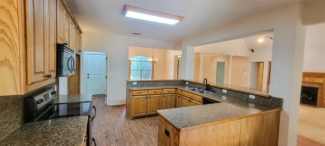 a bathroom with a granite countertop tub sink and mirror