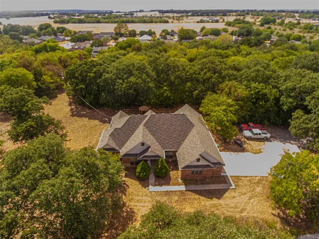 an aerial view of a house with a yard