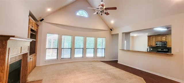 a view of a livingroom with furniture and a ceiling fan