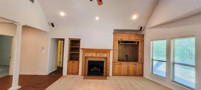 a view of a livingroom with an entryway and a fireplace