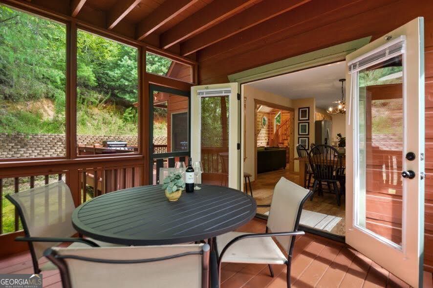 166 Riparian Way Ellijay, GA 30540 - Photo 30 of 34 a dining room with furniture wooden floor and a potted plant