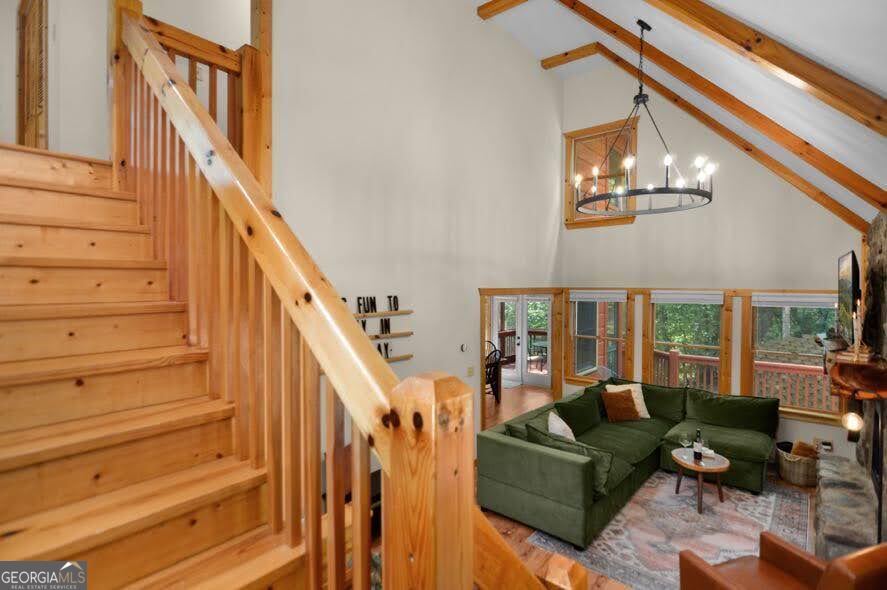 166 Riparian Way Ellijay, GA 30540 - Photo 5 of 34 a living room with furniture and a chandelier