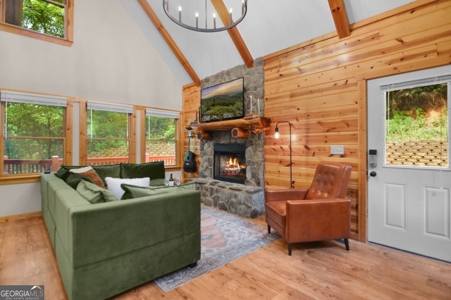 166 Riparian Way Ellijay, GA 30540 - Photo 6 of 34 a living room with furniture a large window and a fireplace