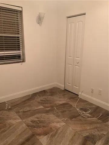 a view of a room with wooden floor and fan
