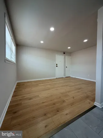 an empty room with wooden floor