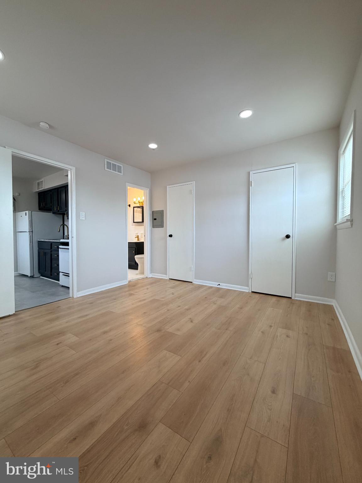 718 Rhawn Street, Unit 45 Philadelphia, PA 19111 - Photo 4 of 6 an empty room with wooden floor and windows