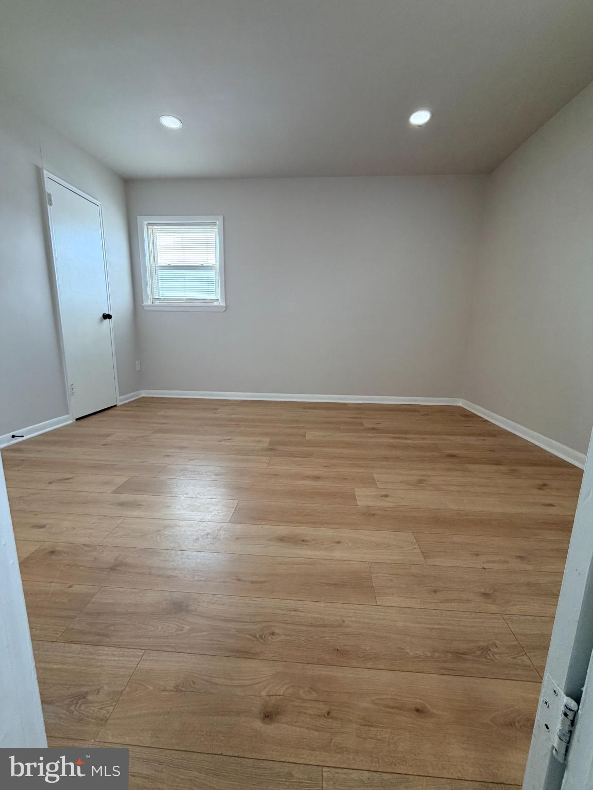 718 Rhawn Street, Unit 45 Philadelphia, PA 19111 - Photo 5 of 6 an empty room with wooden floor and windows