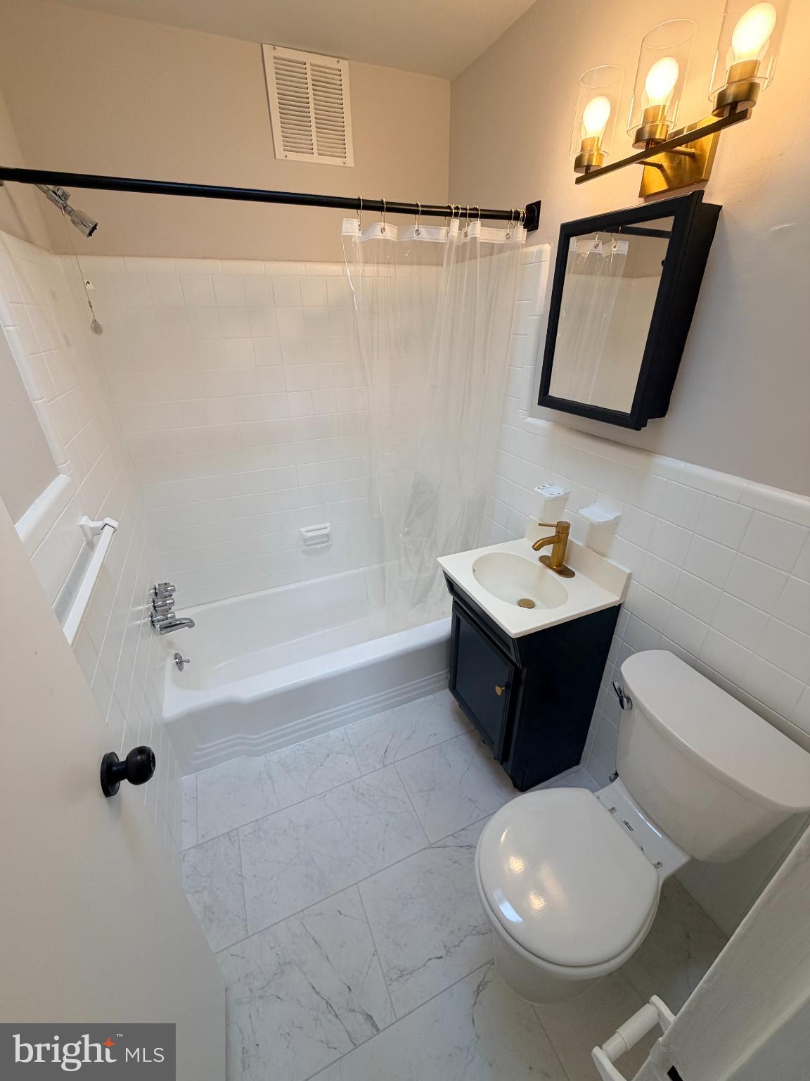 718 Rhawn Street, Unit 45 Philadelphia, PA 19111 - Photo 6 of 6 a bathroom with a sink toilet and shower