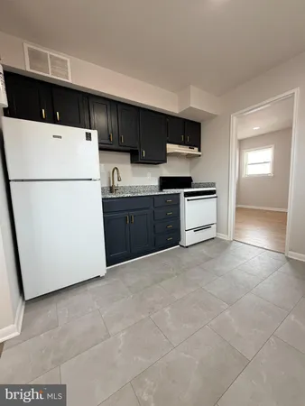 a kitchen with stainless steel appliances granite countertop a refrigerator stove a sink and dishwasher