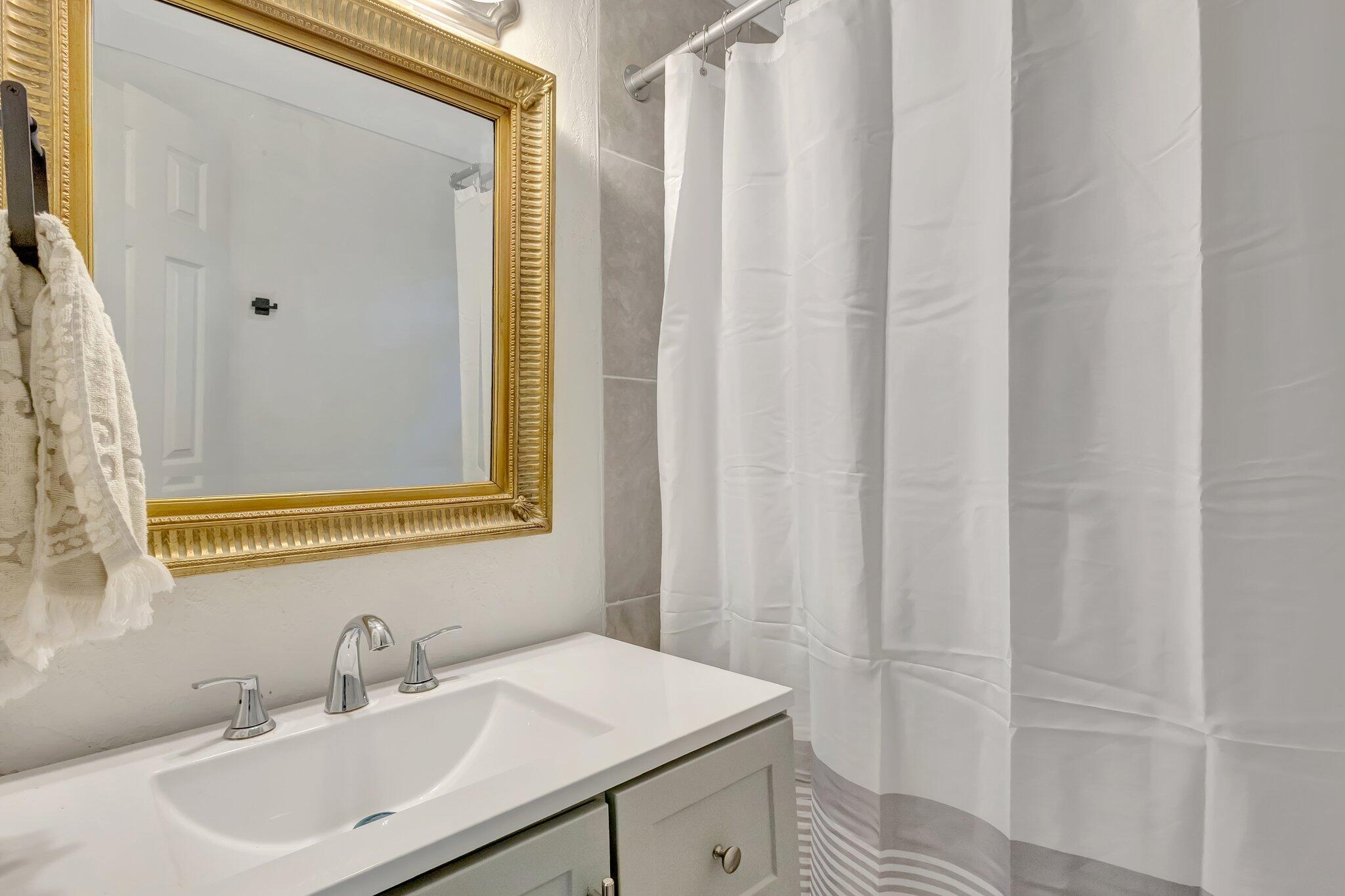 3539 Edwards Road Fort Pierce, FL 34981 - Photo 17 of 39 a bathroom with a sink and a mirror