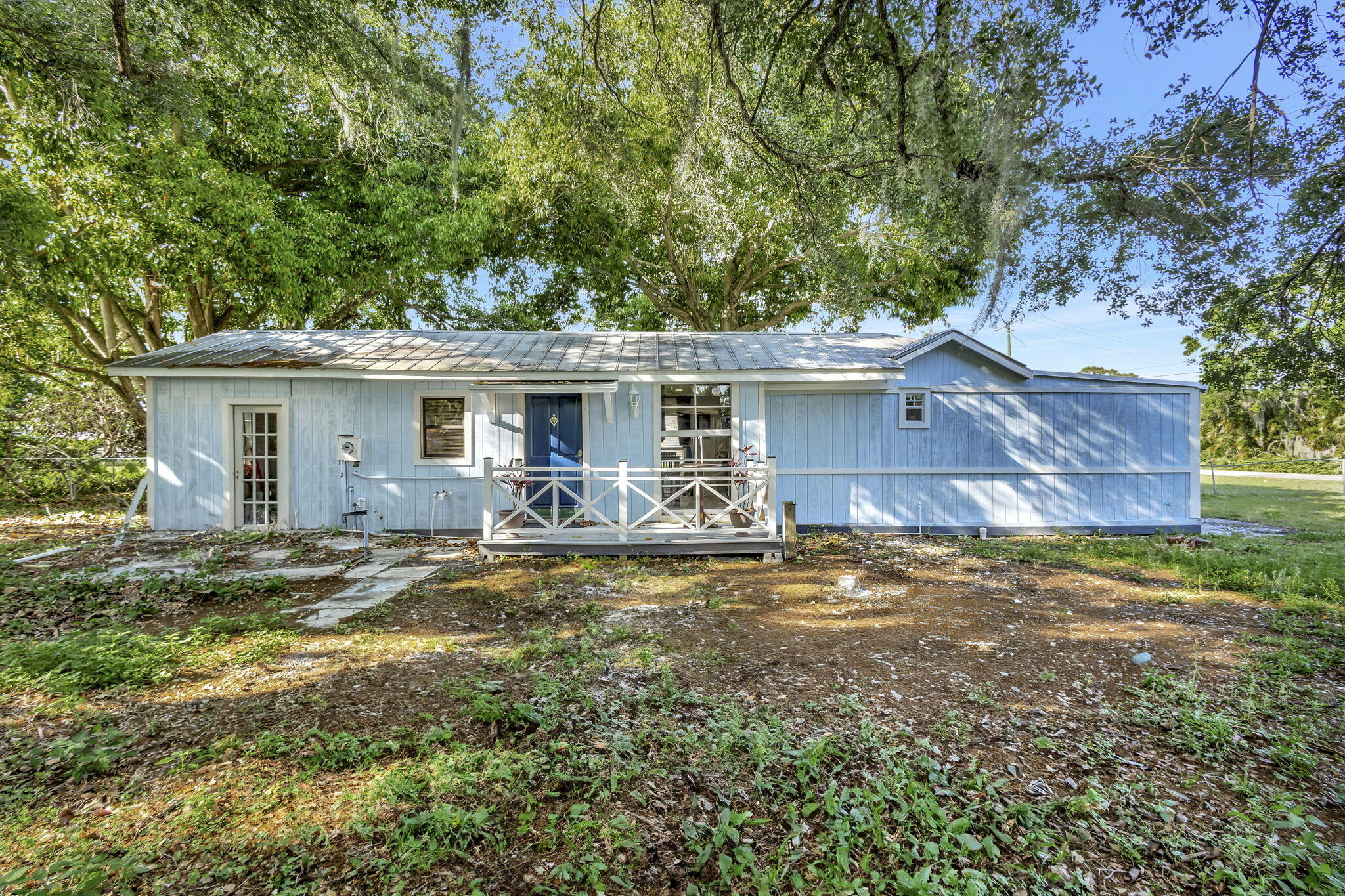 3539 Edwards Road Fort Pierce, FL 34981 - Photo 22 of 39 a view of a yard with a house and a large tree