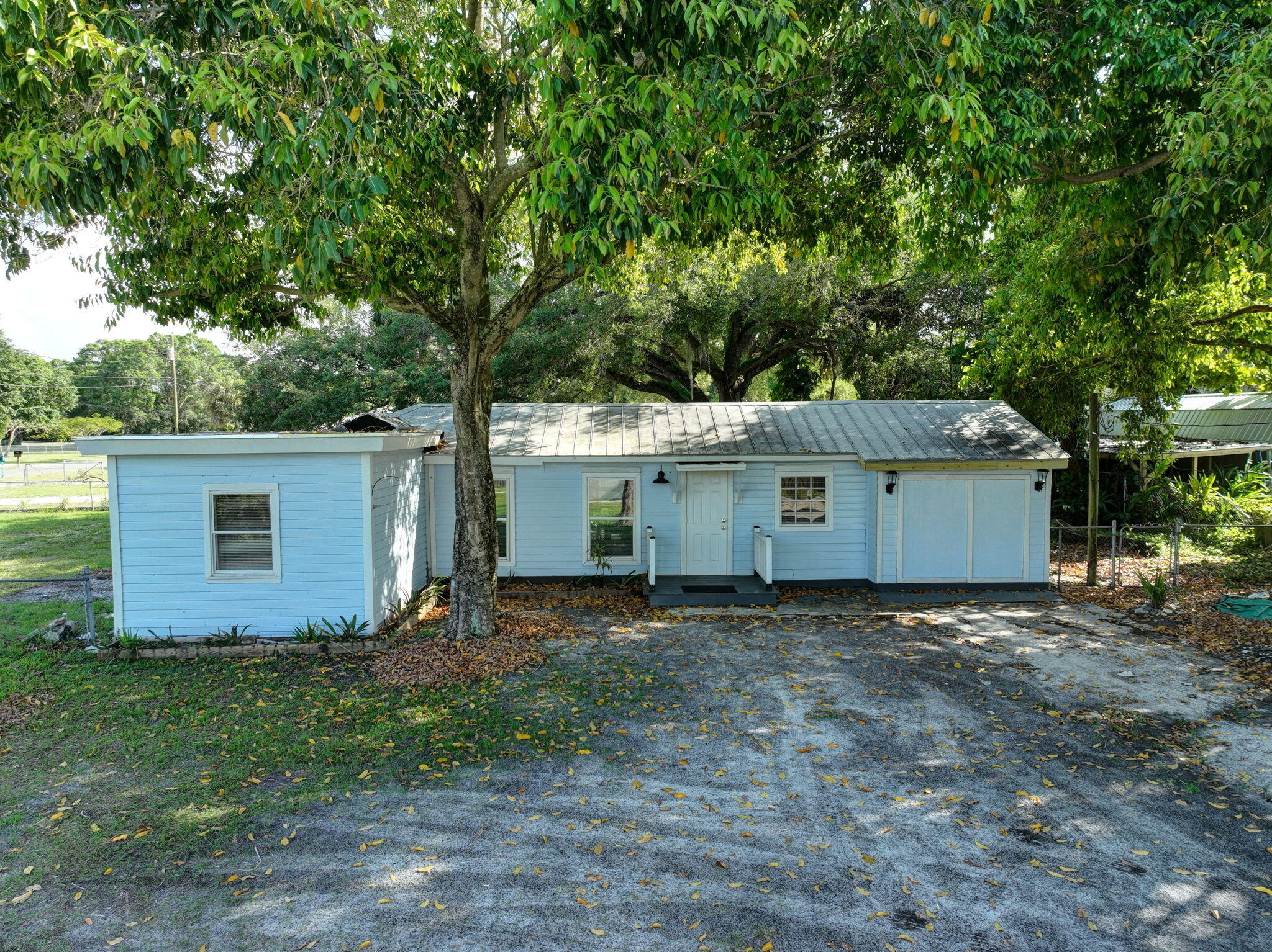 3539 Edwards Road Fort Pierce, FL 34981 - Photo 24 of 39 a view of a house with a yard and large tree