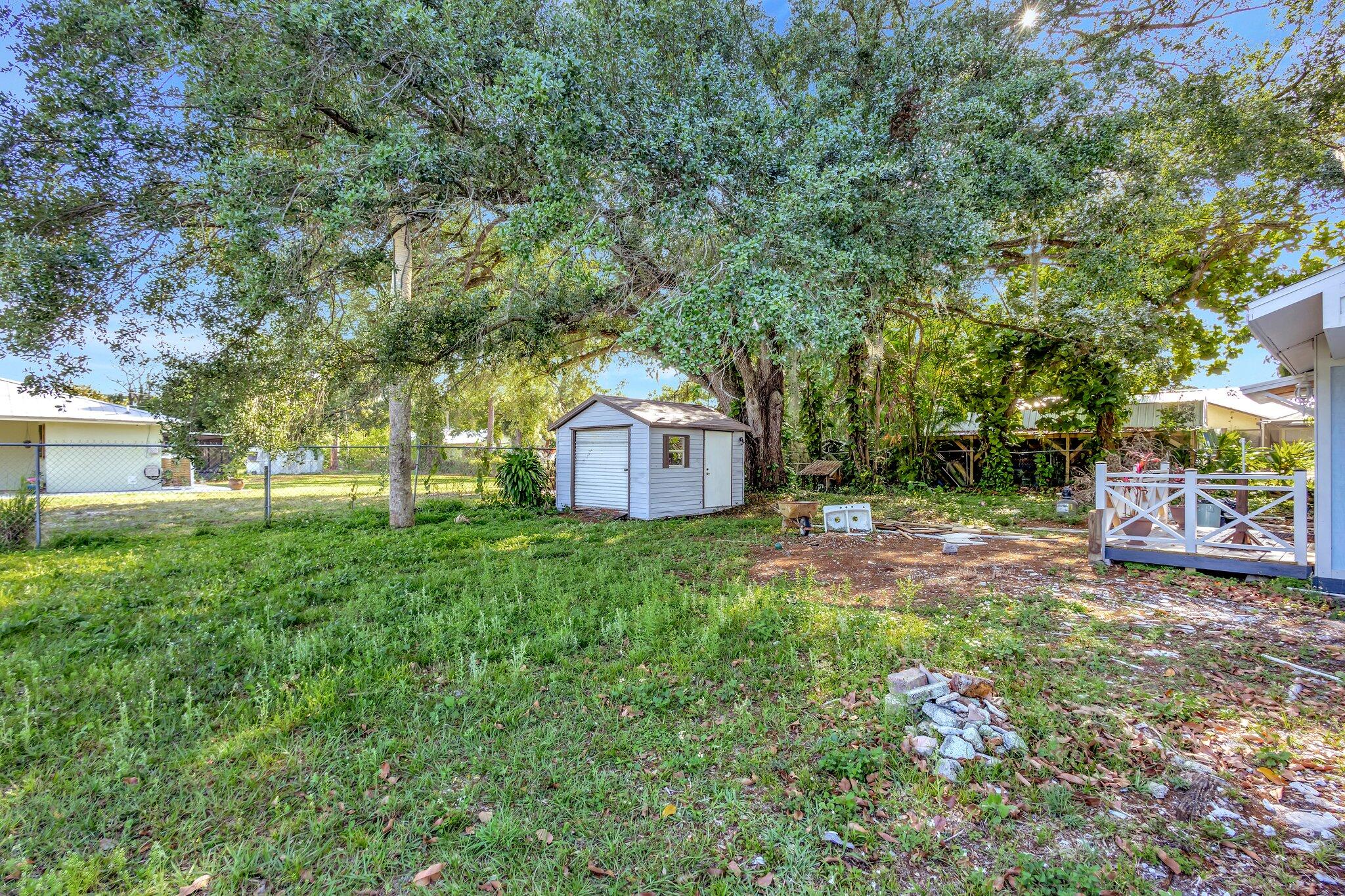 3539 Edwards Road Fort Pierce, FL 34981 - Photo 30 of 39 a backyard of a house with table and chairs