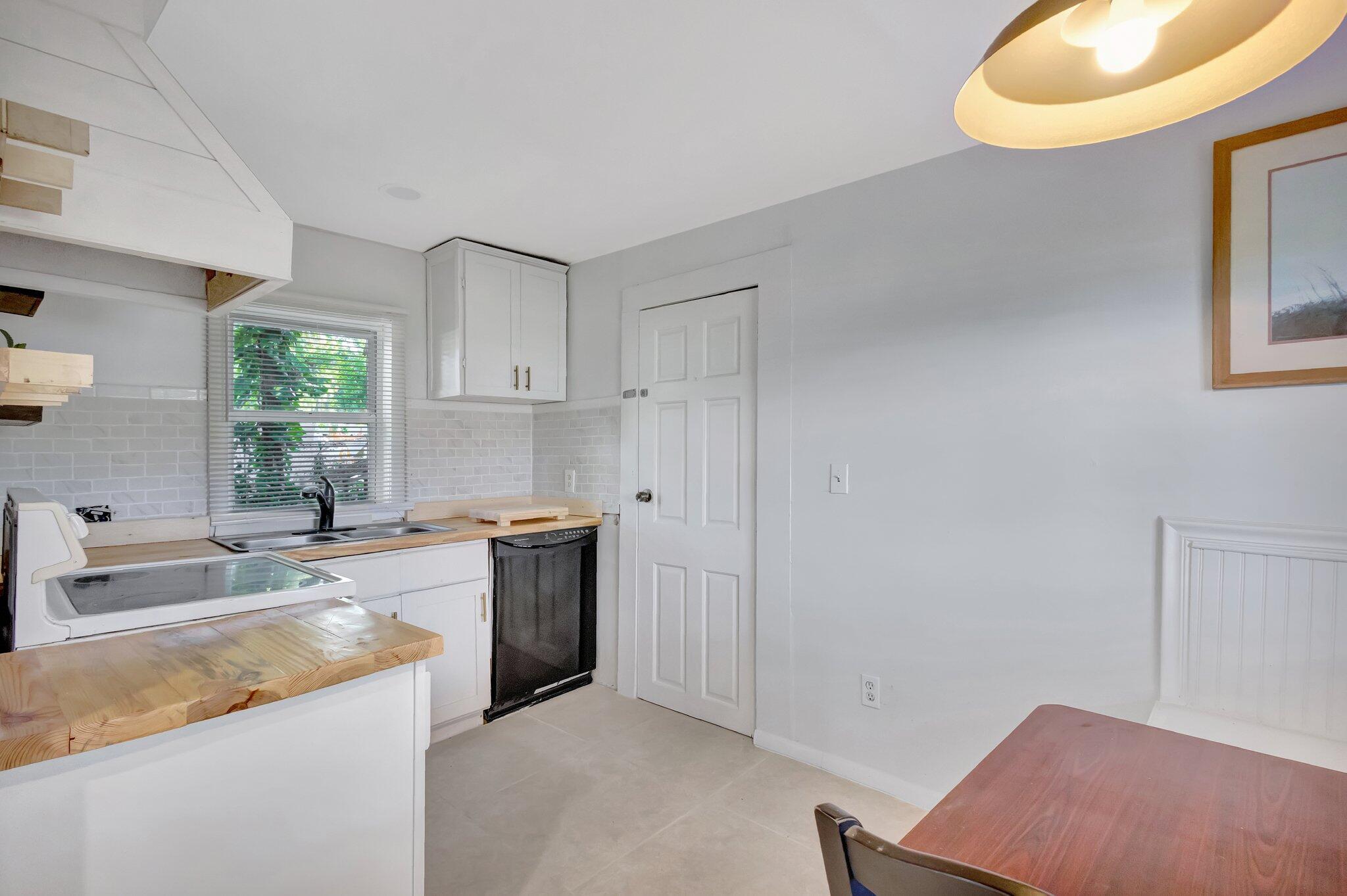 3539 Edwards Road Fort Pierce, FL 34981 - Photo 9 of 39 a kitchen with a sink cabinets and window