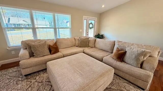 a room with wooden floor and windows