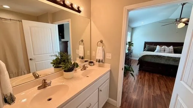 a view of a house with a yard and large trees