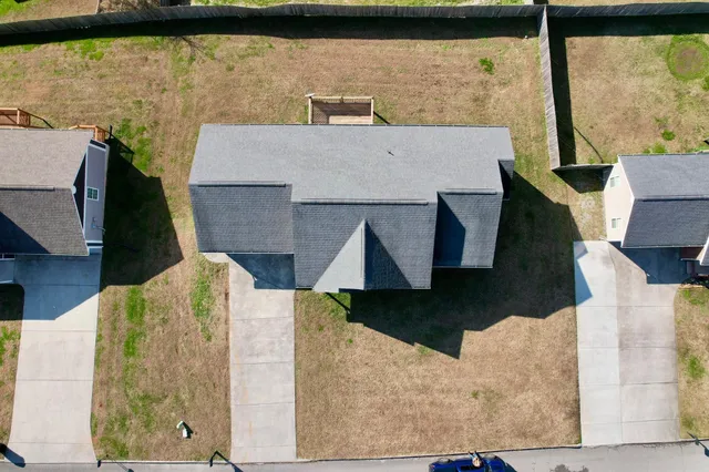 an aerial view of a house with a swimming pool