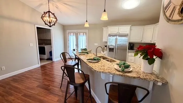 a view of a dining room with furniture and wooden floor