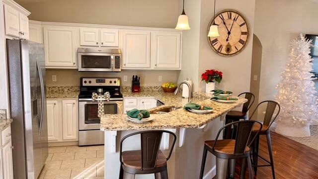 189 Foothills Drive Dayton, TN 37321 - Photo 10 of 18 a kitchen with stainless steel appliances granite countertop a dining table chairs and a refrigerator