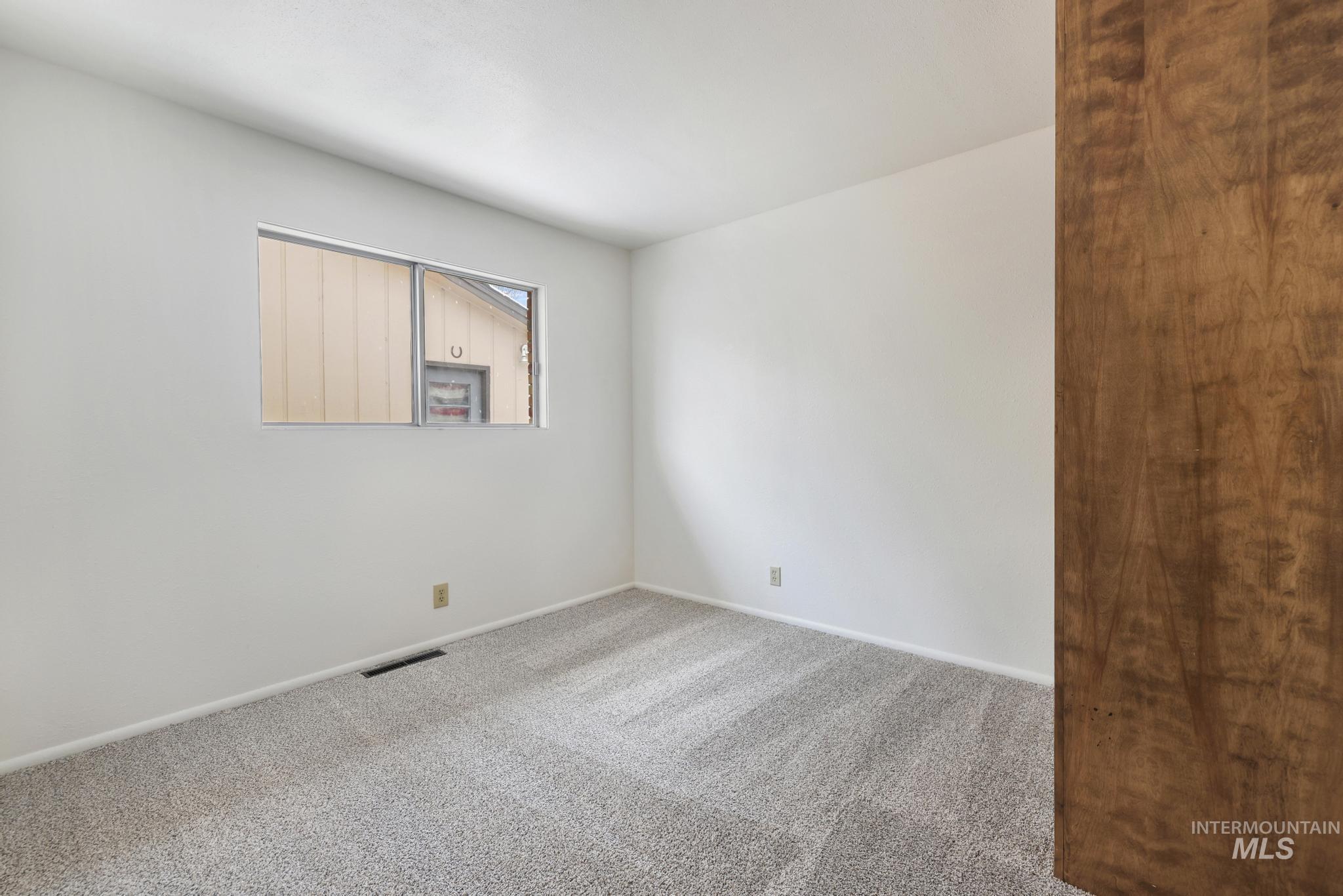 409 Clear Lakes Road Buhl, ID 83316 - Photo 17 of 23 Carpeted empty room featuring baseboards