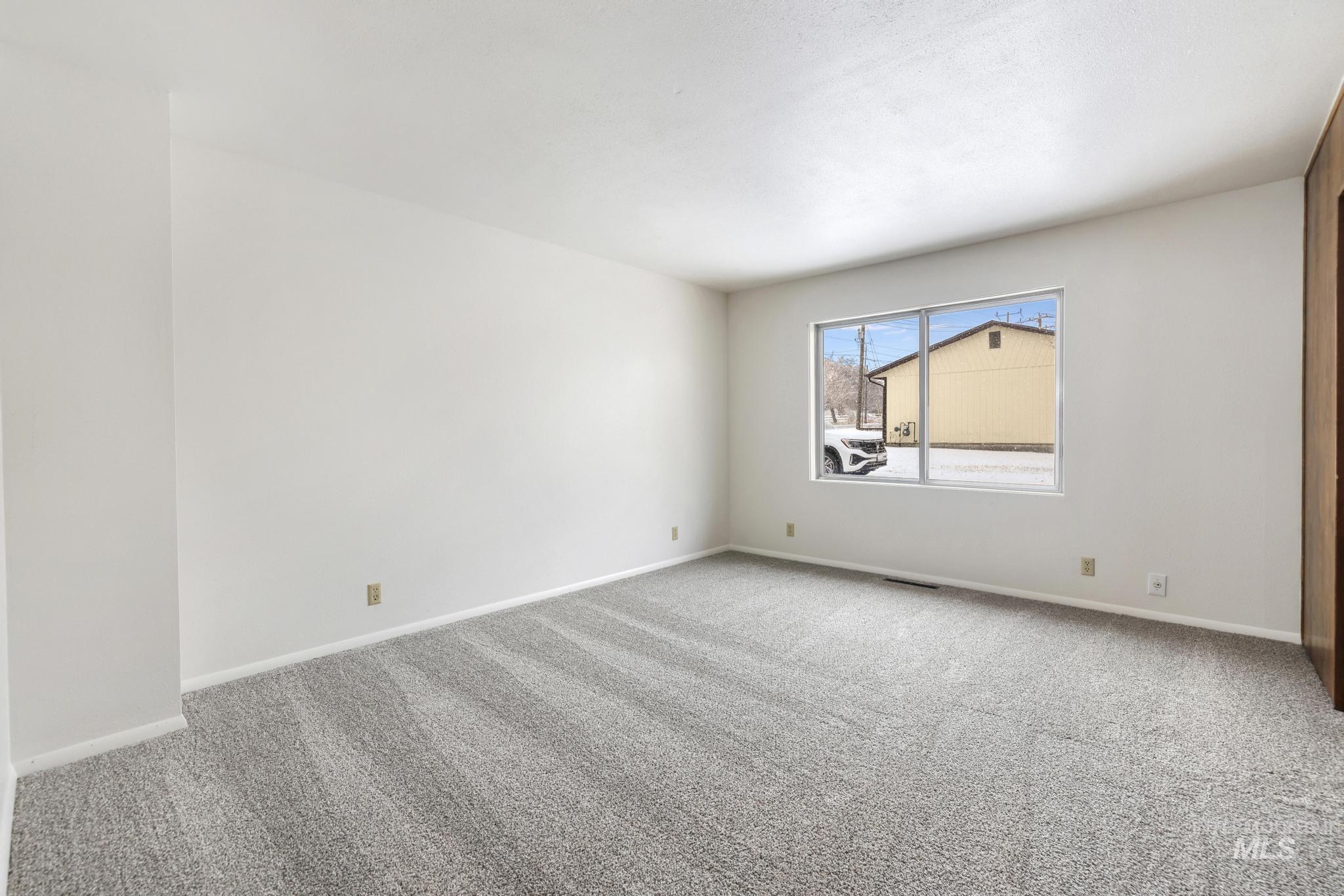 409 Clear Lakes Road Buhl, ID 83316 - Photo 22 of 43 Carpeted empty room featuring baseboards