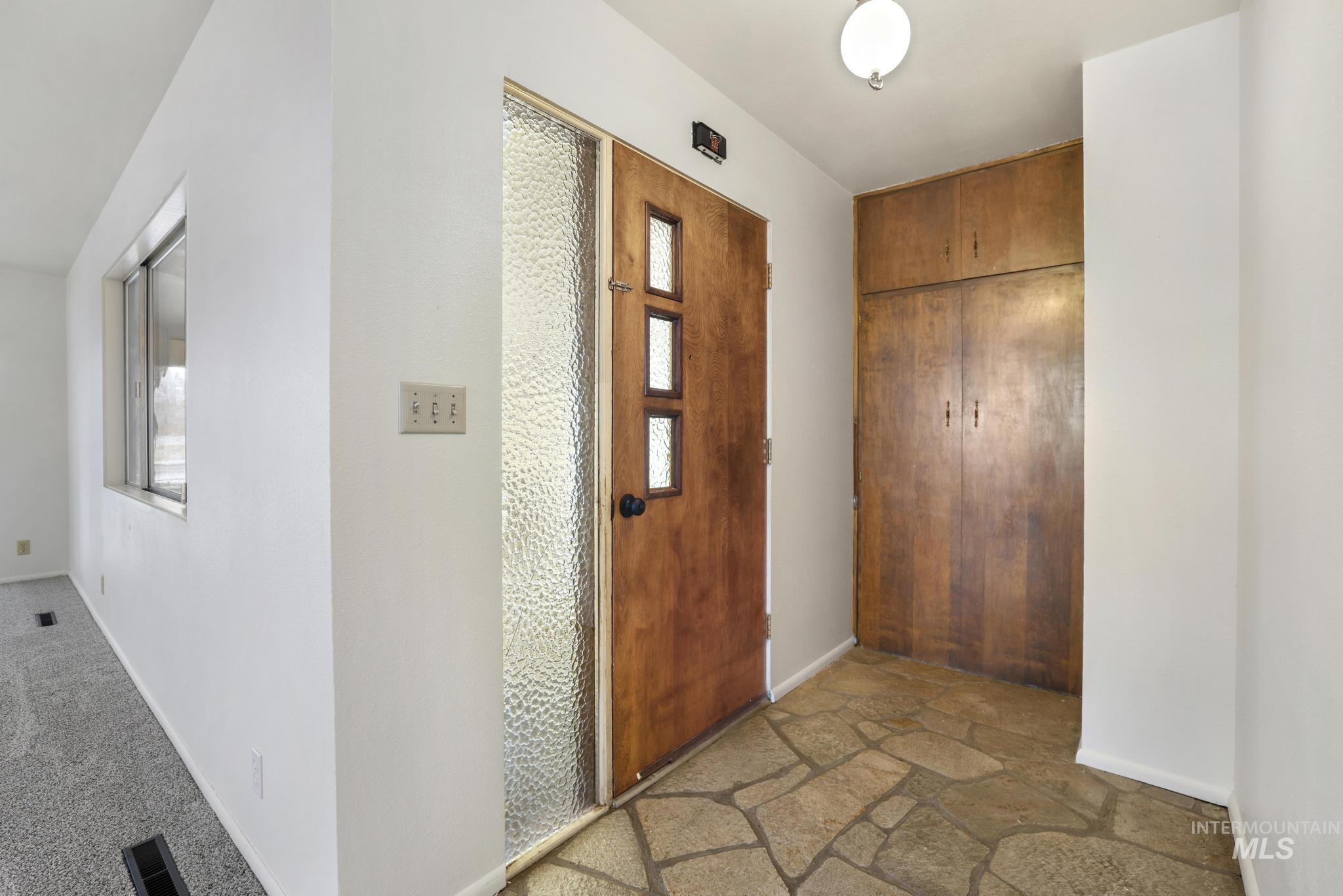 409 Clear Lakes Road Buhl, ID 83316 - Photo 3 of 23 Foyer featuring baseboards and stone finish flooring
