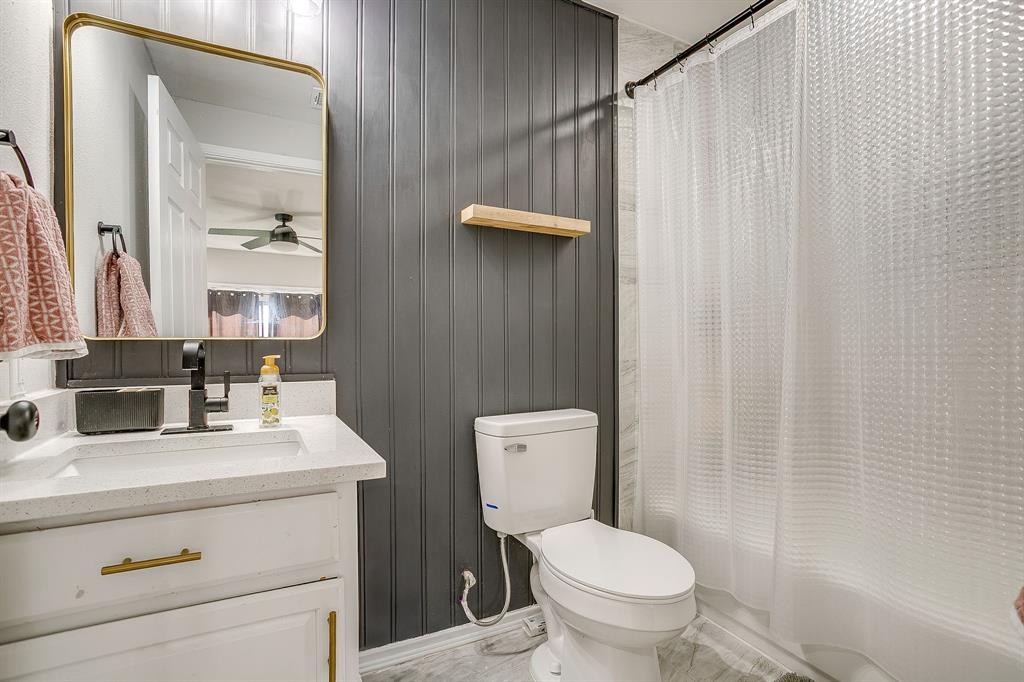 137 Merritt Street Fort Worth, TX 76114 - Photo 11 of 30 a bathroom with a sink a toilet and a mirror