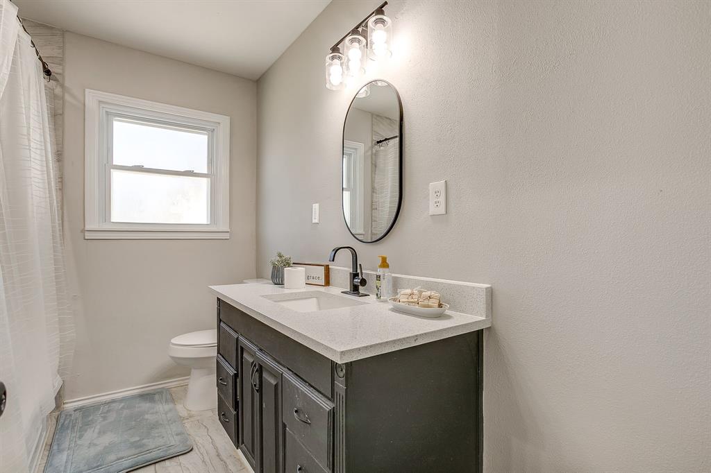 137 Merritt Street Fort Worth, TX 76114 - Photo 14 of 30 a bathroom with a sink and a mirror