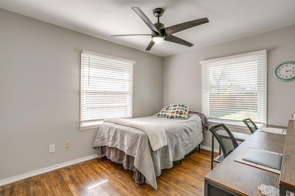 137 Merritt Street Fort Worth, TX 76114 - Photo 17 of 30 a bedroom with a bed and wooden floor