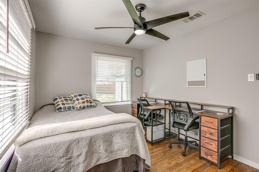 137 Merritt Street Fort Worth, TX 76114 - Photo 18 of 30 a bedroom with a bed and a chandelier