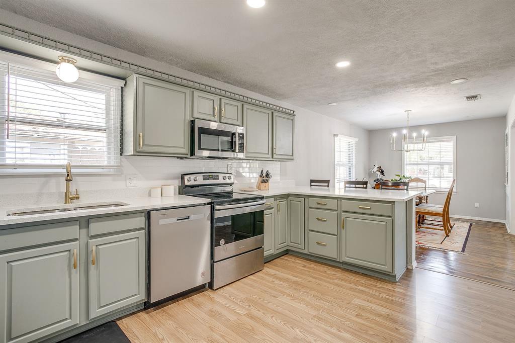 137 Merritt Street Fort Worth, TX 76114 - Photo 6 of 30 a kitchen with sink cabinets and wooden floor