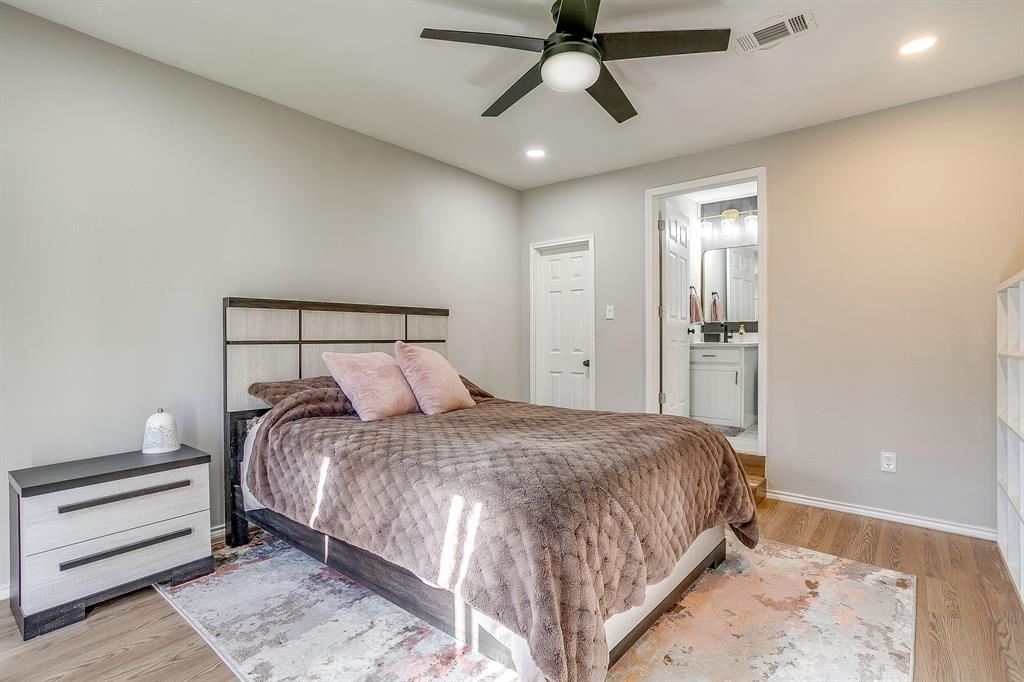 137 Merritt Street Fort Worth, TX 76114 - Photo 9 of 30 a bedroom with a bed and a chandelier