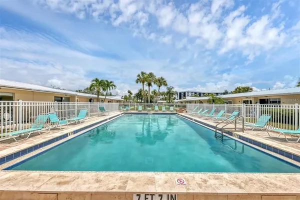 a view of a swimming pool with a yard