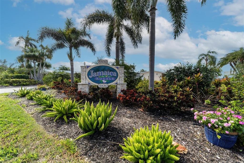 5830 Midnight Pass Road, Unit 54 Sarasota, FL 34242 - Photo 24 of 36 a view of a garden with a flower in a park