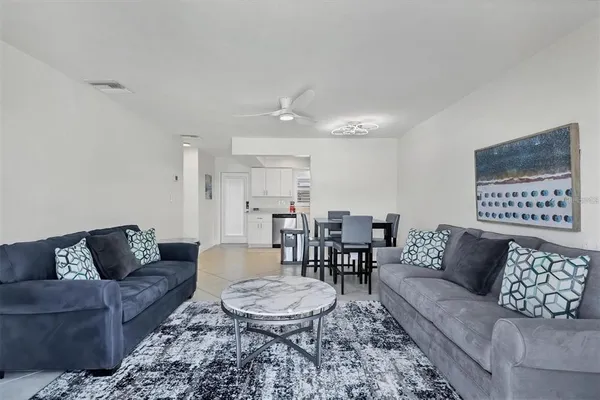 a living room with furniture and a dining table