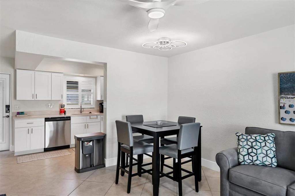 5830 Midnight Pass Road, Unit 54 Sarasota, FL 34242 - Photo 7 of 36 a view of a dining room with furniture and wooden floor