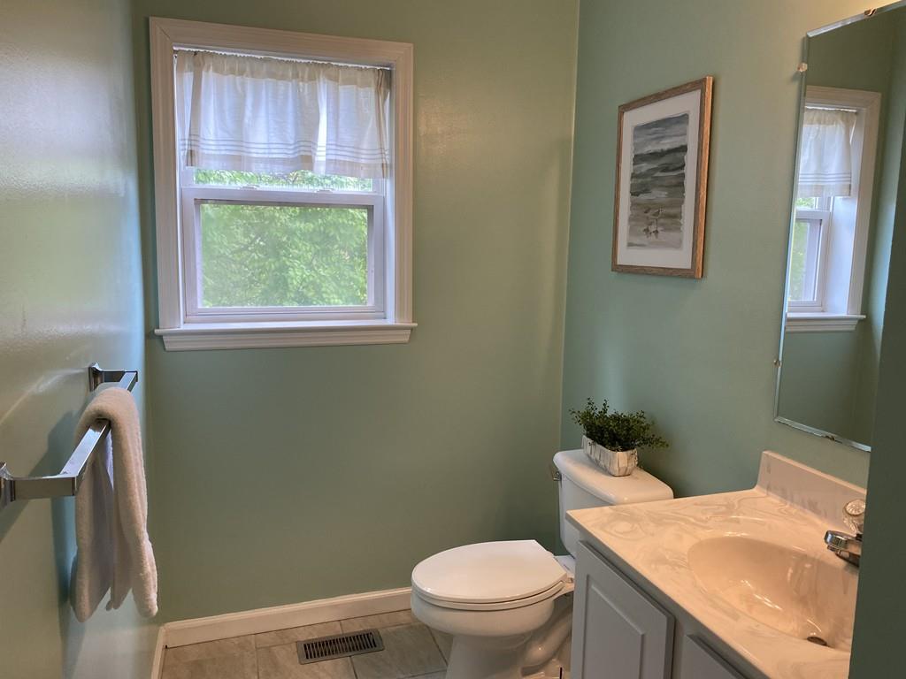 1 Arrowsic Street Worcester, MA 01606 - Photo 11 of 19 a bathroom with a granite countertop toilet sink and mirror