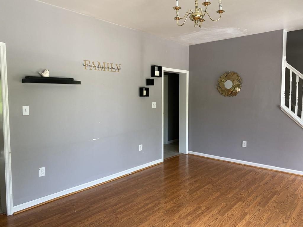 1 Arrowsic Street Worcester, MA 01606 - Photo 4 of 19 a view of an empty room with wooden floor and windows