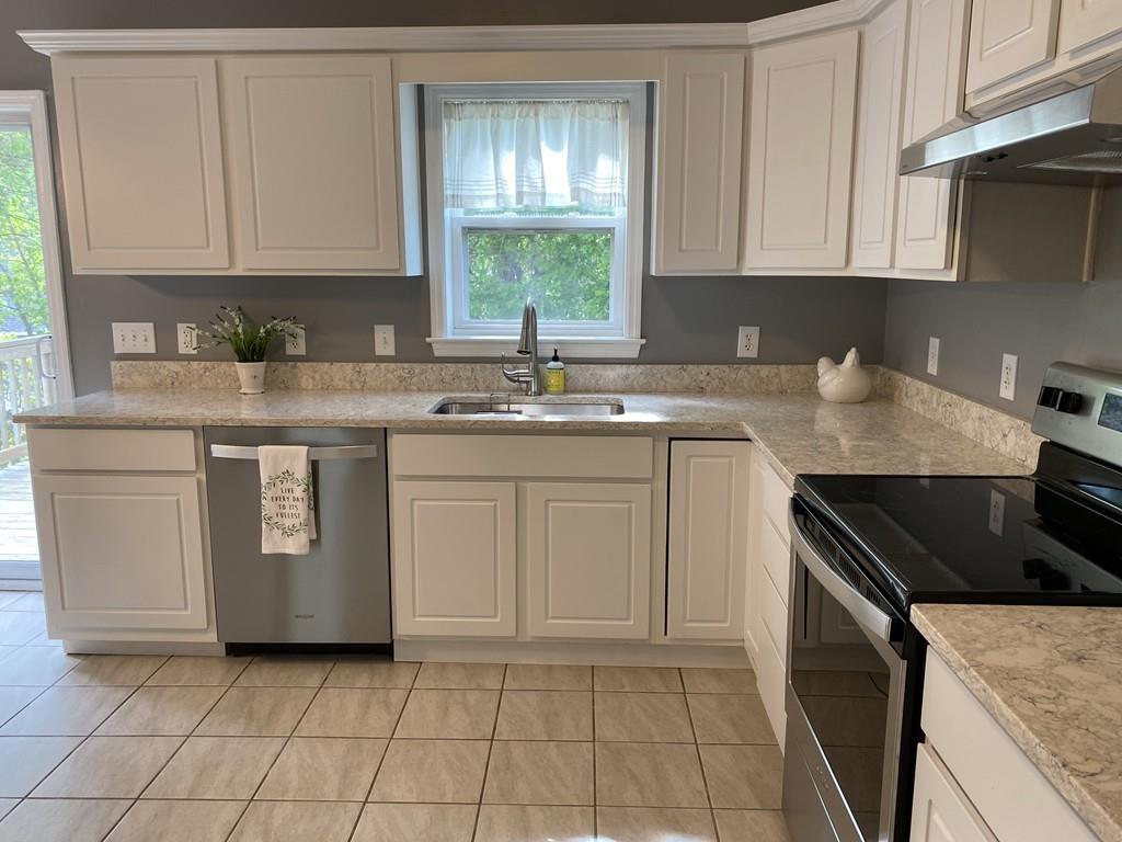 1 Arrowsic Street Worcester, MA 01606 - Photo 6 of 19 a kitchen with a stove sink and cabinets