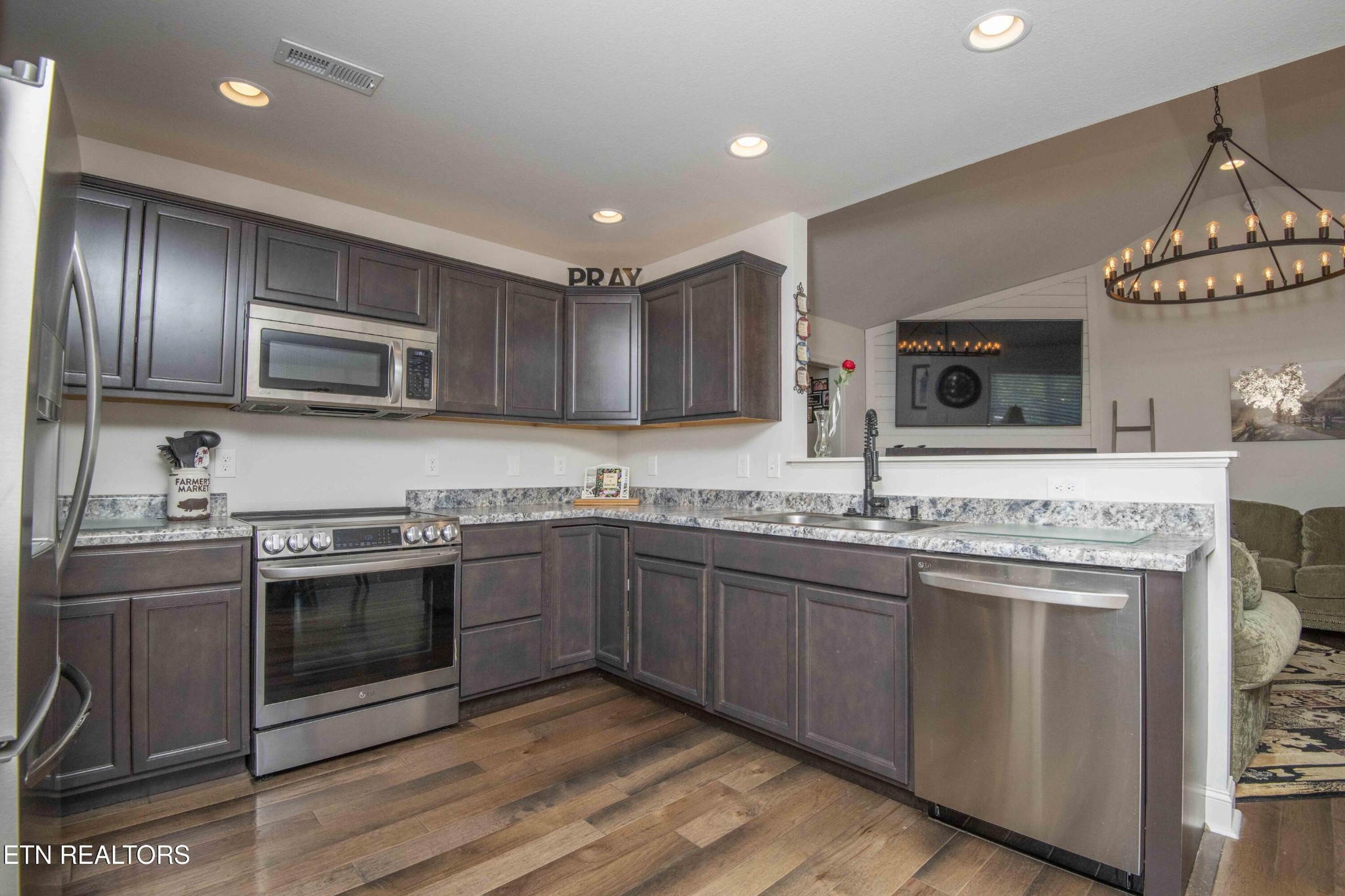 8320 Day Valley Road Powell, TN 37849 - Photo 18 of 35 a kitchen with stainless steel appliances granite countertop a sink and stove top oven