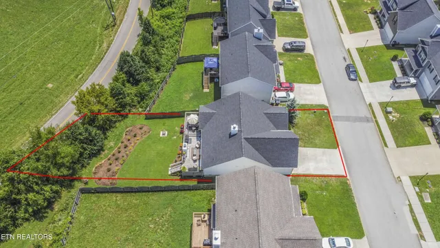 an aerial view of residential houses with outdoor space and swimming pool