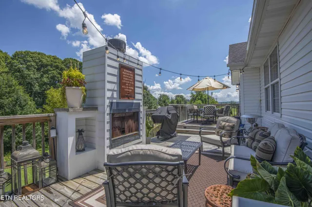a view of balcony with furniture and umbrella