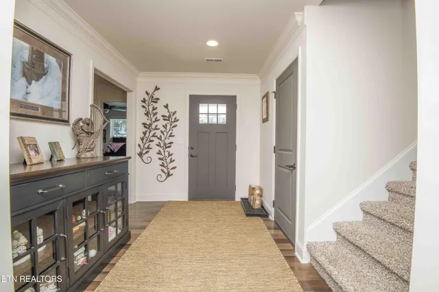 a hallway with a large mirror and cabinets