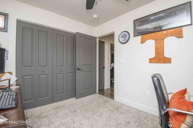 a view of a workspace with furniture and a window