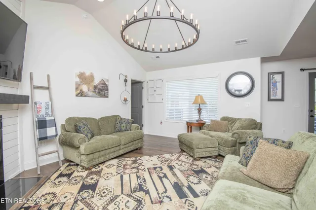 a living room with furniture a flat screen tv and a fireplace